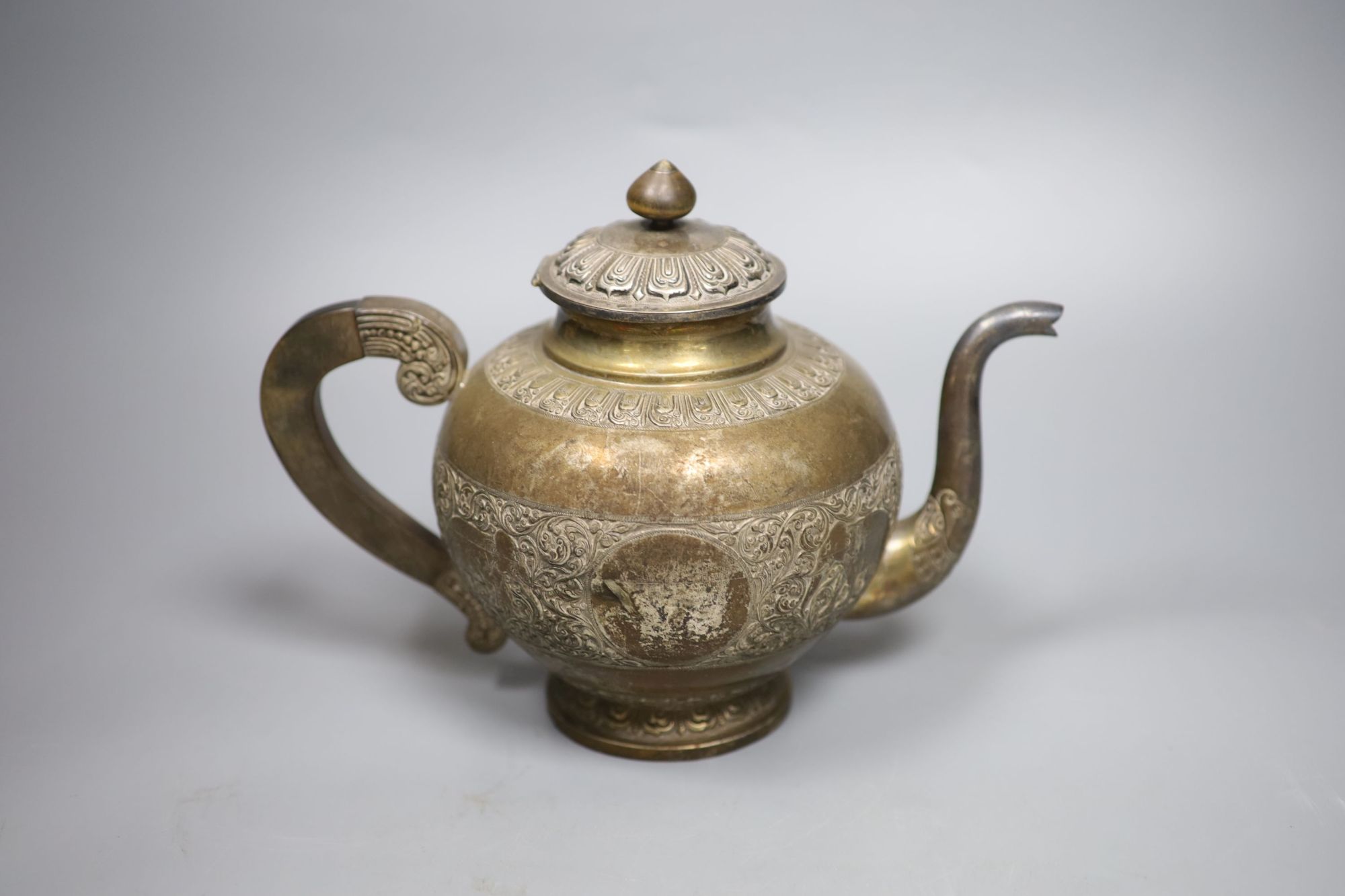 A Ceylonese white metal three piece tea set, teapot height 19.5cm,